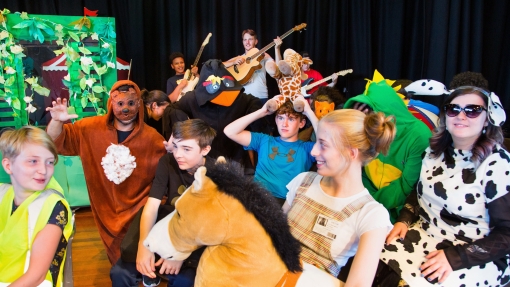 Students in costume performing a bus scene in the play Our Day Out