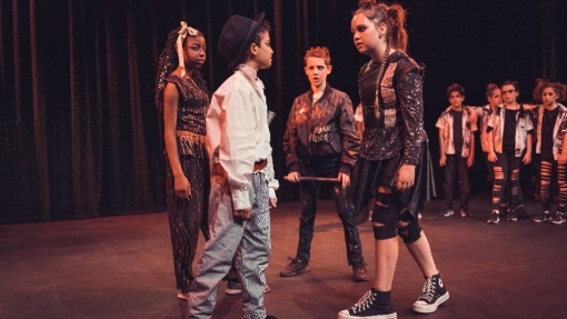 Young people acting on stage in costume