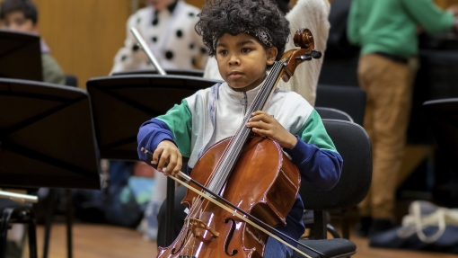 A young person playing cello.