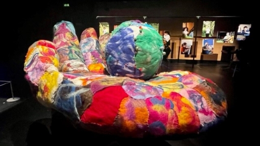 A dark room with bright sculptures lit up in the centre