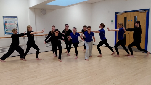 A group of pupils dancing in a hall.