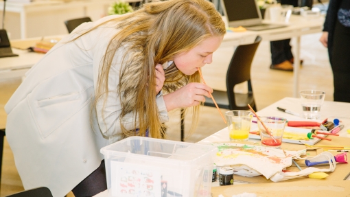 Young person demonstrating methods of tote bag decoration as part of a YOT project at Tate Exchange