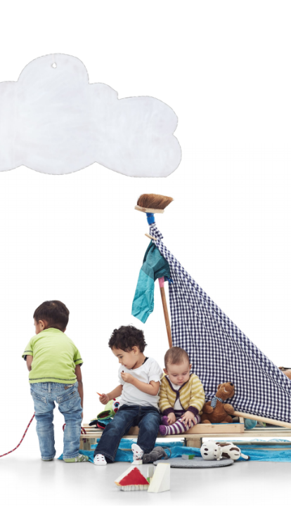 Three children play with a homemade sailboat made from wooden pallets and a checkered cloth sail. One child stands facing away in a green shirt and jeans, while two others sit on the pallet—one holding a toy, the other looking down. Toys like stuffed animals and building blocks are scattered around. The background is plain white with two large, illustrated white clouds.