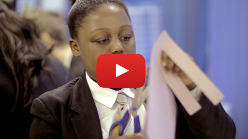 Girl cutting paper with YouTube icon overlaid on image