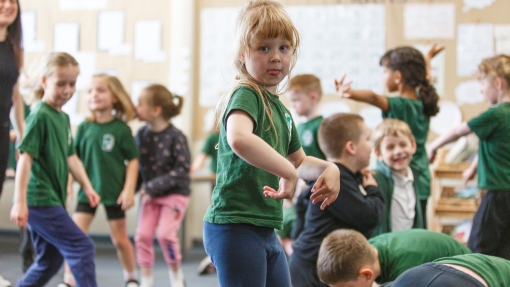 A child dancing in a classroom