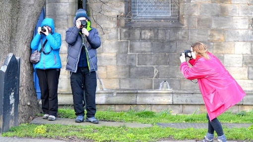 A person taking a photo of people taking photos