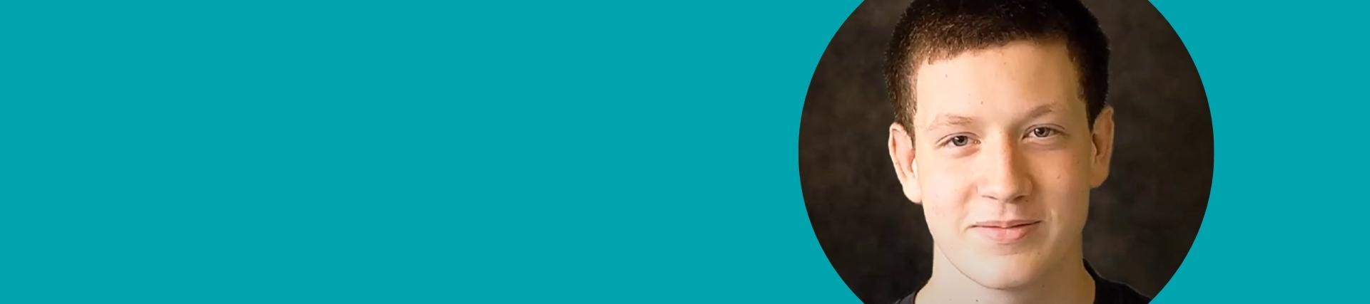 Turquoise banner with an image on the right of a young male pupil straight into the camera.