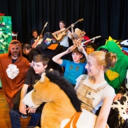 Students in costume performing a bus scene in the play Our Day Out