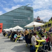 Students from Bolton sitting outside a cultural venue 