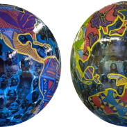 Two globe art sculptures with images of Black Britons on them. 
