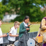 Pupils playing dhol drums, with a professional dhol drummer leading the procession.