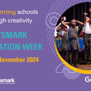 A purple banner with an image on the right of a group of students performing on stage.