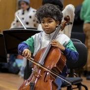 A young person playing cello.