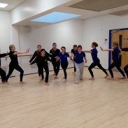 A group of pupils dancing in a hall.