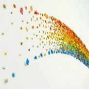 A curved rainbow pattern made of small, colorful objects on a white background. The objects include stars, circles, and irregular shapes, transitioning in color from red to purple.