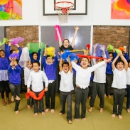 Pupils from Elmhurst Primary School group photo with Artsmark Parter, Artis 