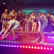 A group of secondary students dancing on stage 