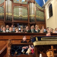 Pupils in singing in a choir in a church setting 