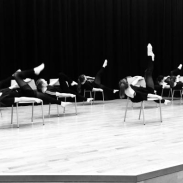 Black and white photo of students performing a dance piece on stage